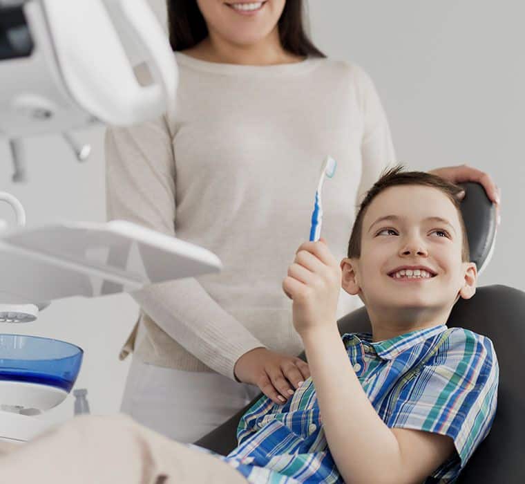 Mother And Son Visiting Dentist Dental Clinic