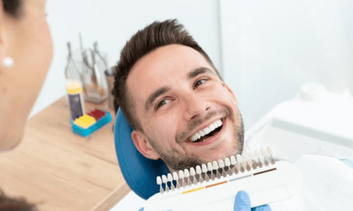 Patient smiling during color tooth matching Patient smiling during color tooth matching