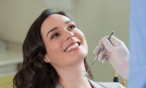 Woman smiling during a dental examination Woman smiling during a dental examination